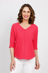 Ten Oh 8 Elbow Sleeve Sweater in Coral. V neck dolman 3/4 sleeve horizontal rib knit. Front center seam. Braid trim at neck, cuff and curved hem. Relaxed fit._t_35432838824136