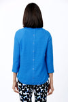 Ten Oh 8 Button Back Sweater in Ocean blue. Crew neck 3/4 sleeve horizontal textural rib. Curved hem. Braid trim at neck, hem and cuff. Button detail down center back. Relaxed fit._t_34826715070664
