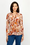Cali Girls Leaves Pleated Blouse in Russet.  Brown, rust and bone leaf print. Pointed collar notched v button down with long sleeves.  Mini pleats through body and sleeve.  Relaxed fit._t_60245547680110
