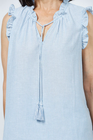 Organic Rags Washable Linen Striped Ruffle Trim Top in Denim and white stripes. V neck with ruffle collar and attached tassel ties. Sleeveless with ruffle trim. A line shape. Side slits. Relaxed fit._35181654442184