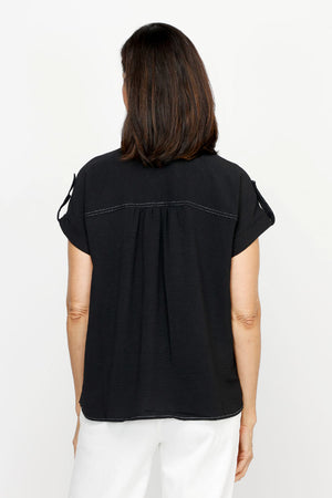 Top Ligne Airflow Contrast Stitch Short Sleeve Blouse in Black.  Pointed collar button down with rolled short sleeve and button tab detail.  Back yoke.  Gathered back. Relaxed fit._61184832209262