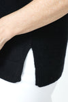 Ten Oh 8 Waffle Short Sleeve V Neck Sweater in Black.  V neck short sleeve waffle weave sweater with dropped shoulder.  Rib trim at neck hem and cuff.  Side slits.  Relaxed fit._t_59988217692526
