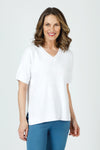 Ten Oh 8 Waffle Short Sleeve V Neck Sweater in White.  V neck short sleeve waffle weave sweater with dropped shoulder.  Rib trim at neck hem and cuff.  Side slits.  Relaxed fit._t_59988217594222