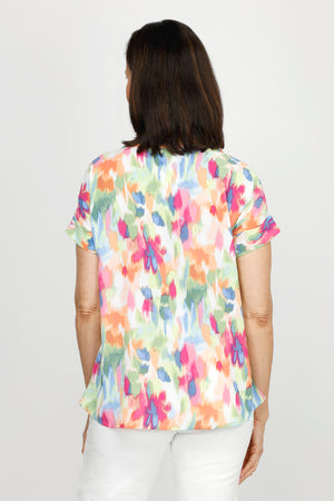 Top Ligne Floral Airflow Round Neck Top in Multi.  Blurred bright multi colored floral print.  Round neck with dolman short sleeve and sewn cuff.  Curved hem.  A line shape.  Relaxed fit._60220240691566