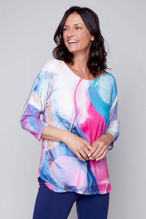 Claire Desjardins Somewhere Warm Dolman Sleeve Top in bright pink and blue abstract swirl top.  Crew neck 3/4 length dolman sleeve top.  Slightly curved hem. Relaxed fit._35184103588040