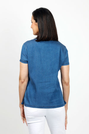 Lolo Luxe Button Pocket Top in Denim. Tencel crew neck with short sleeves. Single breast pocket with pleat and button detail. Top stitch finishing at neck, hem and cuff. Relaxed fit._35035041562824