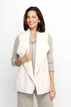 Top Ligne Sherpa Vest in Cream.  Sleeveless faux sheepskin topper.  Large fold back collar.  Open front.  Contour seams.  Front pockets.  Relaxed fit._61517622673774