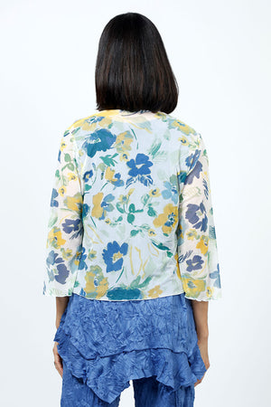 Top Ligne Mesh Floral Cardigan. Blue, yellow and green floral print on a white background. Drape front cropped cardigan with 3/4 flutter sleeve. Sewn edges. Relaxed fit._35195386527944