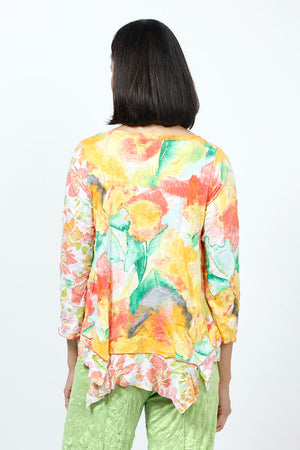 Top Ligne Crinkle Mixed Florals Tee in Mango. Orange, yellow and green floral prints on a white background. Scoop neck 3/4 sleeve top with raised center front seam. 2 different floral patterns on front and sleeves. Asymmetric flounce inset at hem. Relaxed fit._35195838038216