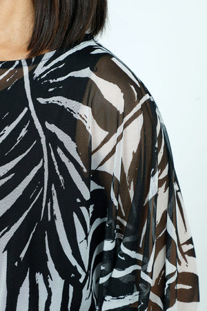 Top Ligne Palm Leaves Sheer Top in Black with white palm leaf print.  Crew neck sheer boxy top with 3/4 dolman sleeve.  Solid black crinkle inset at hem and cuff.  Sharkbite hem.  Oversized fit._52912097067374