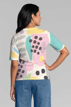 Whimsy Rose Domino Pastel Elbow Sleeve Tee. Bright pink green yellow and blue abstract blocks and black dots on a white background. V neck elbow sleeve a line tee. Relaxed fit._34899418480840