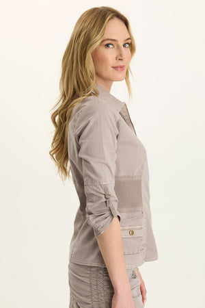 Wearables Wexel Jacket in Foxglove Pigment, a gray beige.  Pointed collar zip front jacket.  3/4 sleeve with twill tape adjustment.  2x1 rib inset at waist and under arms.  Single breast patch pocket.  2 front pouch pockets with button flap extra pocket.  Twill tape accents.  Contour seaming.  Classic fit._61438005707118