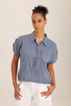 Wearables Abner Top in Hynotic Blue.  Pointed collar button down with short roll tab sleeves.  Raw edges.  Front patch pocket with raw edge trim.  Inset jersey side panels.  High low hem.  Relaxed fit._t_60009031237998
