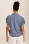 Wearables Abner Top in Hynotic Blue.  Pointed collar button down with short roll tab sleeves.  Raw edges.  Front patch pocket with raw edge trim.  Inset jersey side panels.  High low hem.  Relaxed fit._t_60009031270766