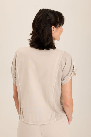 Wearables Abner Top in Ripple pigment.  Pointed collar button down with short roll tab sleeves.  Raw edges.  Front patch pocket with raw edge trim.  Inset jersey side panels.  High low hem.  Relaxed fit._60009031205230