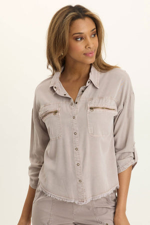 Wearables Knapp Twill Utility Snap Front Blouse in Foxglove.  Pointed collar snap front shirt.  3/4 sleeve with snap tab.  2 front zip breast pockets.  Back yoke in slub jersey.  Slub jersey insets at underarm.  Curved hem.  Fringed hem. Classic fit._61444814733678