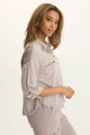 Wearables Knapp Twill Utility Snap Front Blouse in Foxglove.  Pointed collar snap front shirt.  3/4 sleeve with snap tab.  2 front zip breast pockets.  Back yoke in slub jersey.  Slub jersey insets at underarm.  Curved hem.  Fringed hem. Classic fit._t_61444814766446