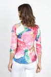 Top Ligne Abstract Flowers V Neck Top in Multi. Bright abstract floral print on a white background. V neck 3/4 sleeve top with a banded neckline. Shirt tail hem. Relaxed fit._t_35013824348360