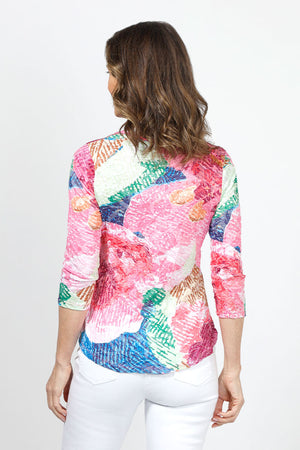 Top Ligne Abstract Flowers V Neck Top in Multi. Bright abstract floral print on a white background. V neck 3/4 sleeve top with a banded neckline. Shirt tail hem. Relaxed fit._35013824348360