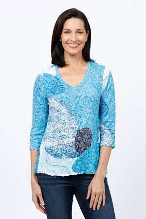 Top Ligne Abstract Rose Shredded Back Top in Blue and White.  Abstract rose tonal print with gradient print and geometric touches.  V neck 3/4 sleeve top in crinkle fabric.  Shredded strips across top of back.  Relaxed fit._34812251635912