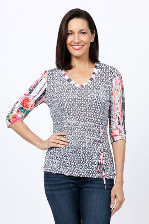 Top Ligne Geo & Print Grommet Top.  Geo print body with floral print sleeves and trim.  Grommet and lace detail at hem. Relaxed fit._34812277948616