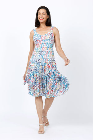Top Ligne Mixed Directions Tank Dress.  Bright multi colored geometric print on a white background.  Scoop neck tank dress with asymmetric tiered ruffle skirt.  Swing shape.  Relaxed fit._34842635469000