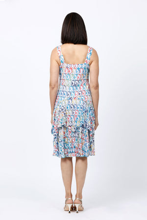 Top Ligne Mixed Directions Tank Dress. Bright multi colored geometric print on a white background. Scoop neck tank dress with asymmetric tiered ruffle skirt. Swing shape. Relaxed fit._34842635370696