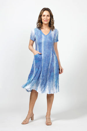 Top Ligne Lines Bubble Dress in Blue Multi.  Gradent blue and white vertical lines print.  V neck short sleeve dress with 2 front slash pockets.  Dress has internal ties below hip that can be tied or not to change the hem line.  A line shape. Relaxed fit._35000114806984