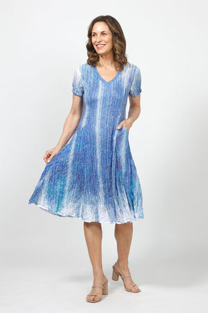 Top Ligne Lines Bubble Dress in Blue Multi. Gradent blue and white vertical lines print. V neck short sleeve dress with 2 front slash pockets. Dress has internal ties below hip that can be tied or not to change the hem line. A line shape. Relaxed fit._35000114970824