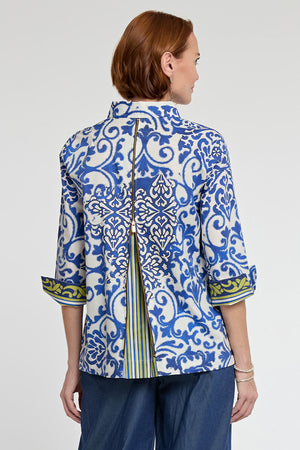 Hinson Wu Xena Damask Zip Back Blouse in Multi. Electric blue and gold scroll print on an off white background. Pointed collar button down with covered button placket and 1 exposed gold button. 3/4 sleeve with split cuff reverses to stripe and scroll print. Gold tone zipper in back unzips to reveal striped inverted pleat. Relaxed fit._34998442131656