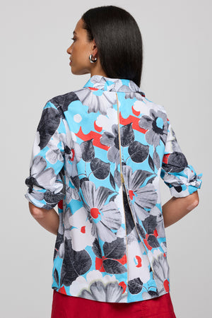Hinson Wu Xena Floral Zip Back Blouse in Blue combo.  Floral shapes in shades of blue, black and pops of red.  Pointed collar with hidden button placket.  Single gold button exposed at neck.  3/4 sleeve with split turn back cuff.  Zip back with solid navy lining.  Relaxed fit._60058071466350