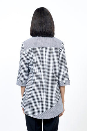 Cali Girls Jenna Mixed Check Blouse in Black/White. Mixed check blouse with different size checks. Pointed collar button down blouse with 3/4 sleeve and smaller check turn back cuff. 2 asymmetric front ruffles in small check. Back yoke in small check. Shirt tail hem. Relaxed fit._34546711953608