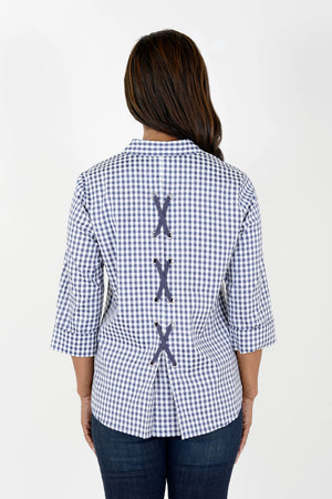 Cali Girls Gingham Lace Up in Blue/White. navy and white gingham check button down blouse. Pointed collar, 3/4 sleeve with turn back cuff. Back inverted pleat with crisscross navy ribbon lacing. Relaxed fit._34626627010760