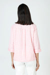 Cali Girls Judy Gingham Blouse in Pink/White.  Mixed size checks.  Pointed collar with open v.  Button front.  3/4 sleeve with fold back cuff.  Single breast patch pocket.  Back yoke with double loop detail.  Side seams wrap slightly to front with curved hem.  Relaxed fit._t_59821610434926