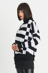 Planet Slanted Sweater in Black/White. Geometric squares and slanted rectangles print front and back. Mock neck with long sleeves. Drop shoulders. Rib trim at neck, cuff and hem. Side slits. Oversized fit. Shorter length. One size fits many._t_34273311523016
