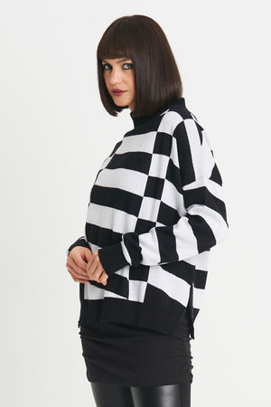 Planet Slanted Sweater in Black/White. Geometric squares and slanted rectangles print front and back. Mock neck with long sleeves. Drop shoulders. Rib trim at neck, cuff and hem. Side slits. Oversized fit. Shorter length. One size fits many._34273311523016
