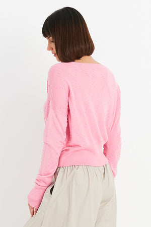 Planet Swiss Dot Sweater in Bubblegum pink. Crew neck oversized crop sweater. Drop shoulder. Textural knit raised dots in a diamond pattern. Rib trim at neck, hem and cuff. Oversized fit._34818362507464