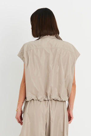 Planet Mini Cargo Vest in Fawn. Pointed collar button down cropped vest with covered button placket. 2 front lap large cargo pockets. Elastic cinching at hem. One size fits many._34923728765128