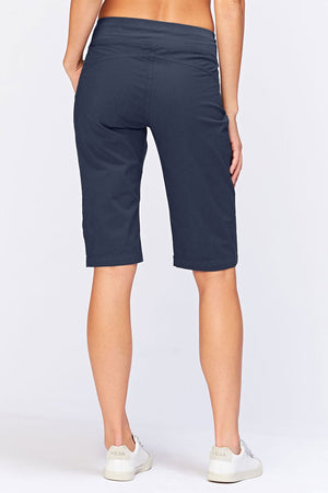 Wearables Tatem Bermuda in Navy. 2 1/2" elastic jersey waistband. Poplin body. Front center seams with ruch detail at sides. Curved back yoke. 10" rise in front; 15 1/2"in back. 14 1/2" inseam._34980812161224