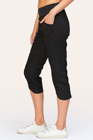 Wearables Iris Crop in Black.  2 1/2" jersey waistband with poplin body.  2 deep front pockets with grommet detail.  Center seams and contour seams.  Ruched detail front and back.  Front tulip hem.  22" inseam._61270052864366