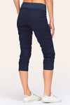 Wearables Iris Crop in Navy.  2 1/2" jersey waistband with poplin body.  2 deep front pockets with grommet detail.  Center seams and contour seams.  Ruched detail front and back.  Front tulip hem.  22" inseam._t_61270052995438