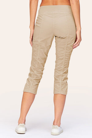Wearables Iris Crop in Sand.  2 1/2" jersey waistband with poplin body.  2 deep front pockets with grommet detail.  Center seams and contour seams.  Ruched detail front and back.  Front tulip hem.  22" inseam._61270053093742