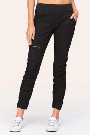 Wearables Malanda Pant in Black.  Pull on pant with 2 1/2" jersey elastic waistband.  Poplin body.  2 front slash pockets.  1 single zip front pocket.  Contour seams.  Ruched detail on front leg.  Jersey insets at side.  28" inseam. _61269626290542