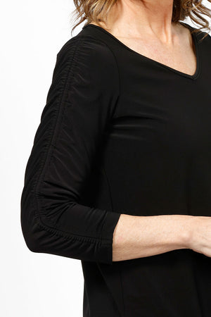 Sympli Revelry Ruched Sleeve Top in Black. V neck 3/4 sleeve with ruch detail down center sleeve. Side slits. A line shape. Relaxed fit._35242310697160