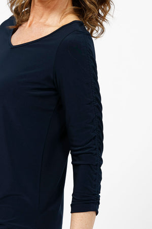 Sympli Revelry Ruched Sleeve Top in Navy. V neck 3/4 sleeve with ruched detail down center sleeve. Side slits. A line shape. Relaxed fit._35242310959304