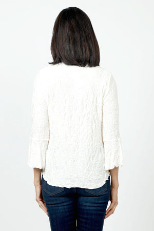 Sno Skins Dream V Neck Top in White. Textured swirl tone on tone print. V neck top with 3/4 bell sleeve. Curved hem. Relaxed fit._34622208737480