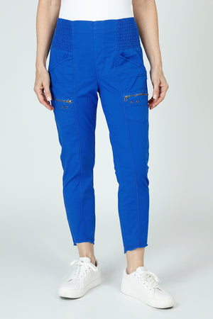 Wearables Acker Slim Pant in Honorable Blue, a bright blue.  Pull on Pant with shirred elastic panels at sides.  2 front slash pockets and zip cargo pockets.  High low hem. Inseam 26"_59448483283310