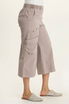 Wearables Faulkner Crop Pant in Foxglove, a gray beige.  Jersey knit elastic waistband pull on wide leg crop.  2 front slash pockets and 2 front flap cargo pockets.  Antique brass grommet trim.  24" inseam._t_61437221994862