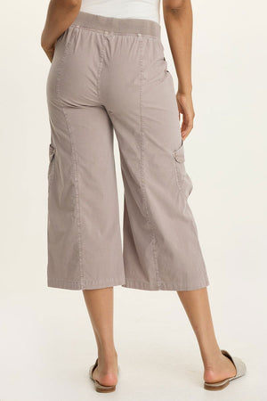 Wearables Faulkner Crop Pant in Foxglove, a gray beige.  Jersey knit elastic waistband pull on wide leg crop.  2 front slash pockets and 2 front flap cargo pockets.  Antique brass grommet trim.  24" inseam._61437222027630