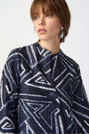 Joseph Ribkoff Geometric Jacquard Jacket. White bold geometric print on a midnight blue background. Stand collar with asymmetric 1 button closure. 3/4 sleeve with wide cuff. High low hem. Relaxed fit._t_34829092880584